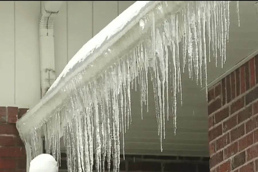 Ice collected along a winter roof edge
