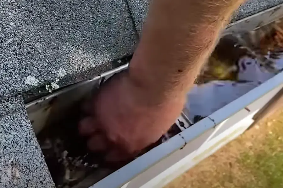 Clearing leaves from an open residential gutter